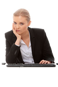 Young woman using smart phone against white background