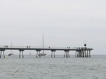 Pier over sea against clear sky