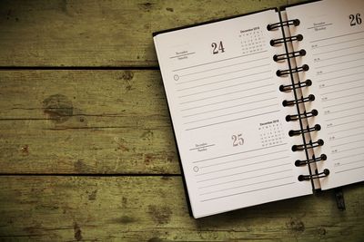 Close-up of diary on wooden table