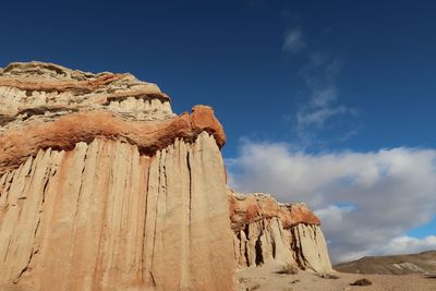 Low angle view of rock formation against sky