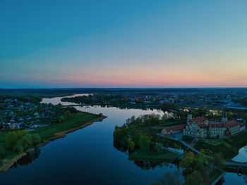 High angle view of river and cityscape against clear sky