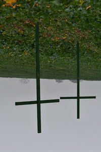 Cross on field against sky