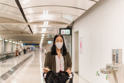 Full length portrait of woman standing in bus