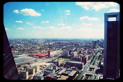 Cityscape against cloudy sky