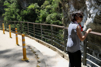 Woman standing on footbridge