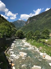 Scenic view of river amidst mountains against sky