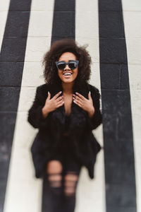 Portrait of woman wearing sunglasses standing outdoors