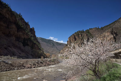 Scenic view of rocky mountains against clear blue sky