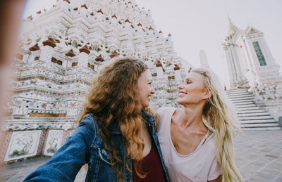 Happy women at temple in city