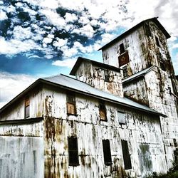 Low angle view of building against cloudy sky