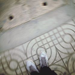 Low section of people standing on tiled floor
