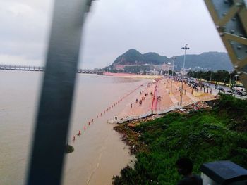 High angle view of road by city against sky