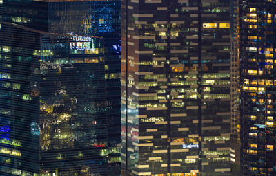 Illuminated modern buildings in city at night