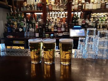 Glass of wine bottles on table