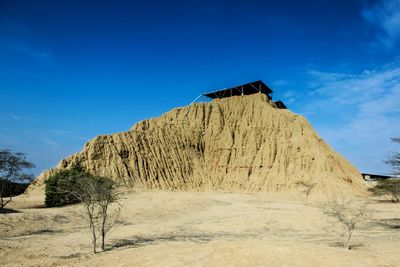 Scenic view of mountain against blue sky