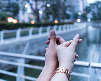 Close-up of hand on railing against blurred background