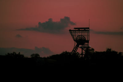 Silhouette built structure against sky during sunset