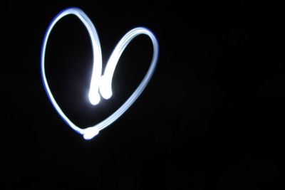 Close-up of light bulb over black background