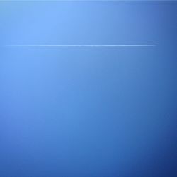 Vapor trail against clear blue sky