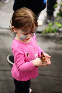 Girl holding butterfly