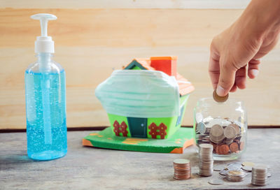 Close-up of hand holding ice cream on table