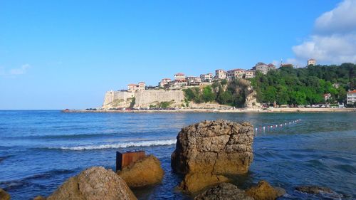 Scenic view of sea against clear blue sky