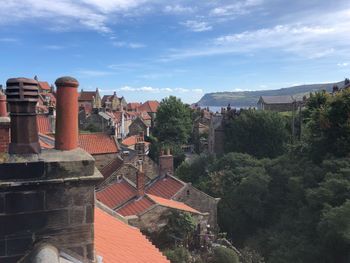High angle view of trees and buildings against sky