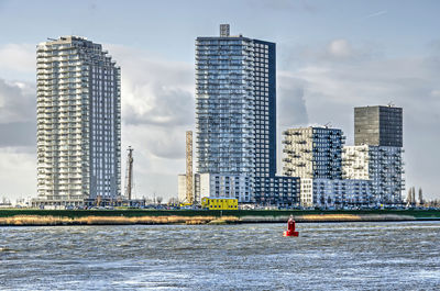 Modern residential towers and the river oude maas in spijkenisse