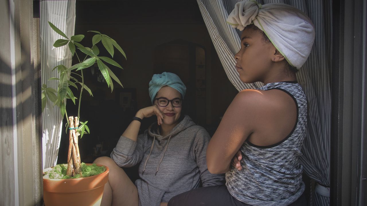 potted plant, togetherness, real people, plant, two people, bonding, lifestyles, indoors, young women, growth, smiling, day, sitting, young adult, friendship, people, adult