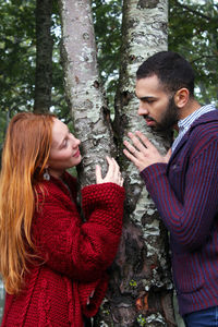 Young couple kissing in forest