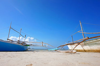 View of boats against blue sky