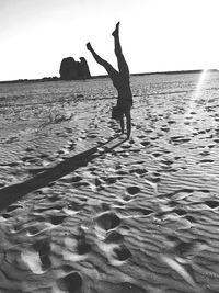 Full length of silhouette person on beach against sky