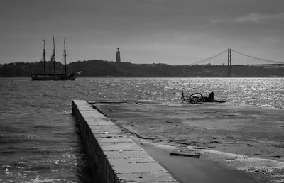 View of people on bridge over sea