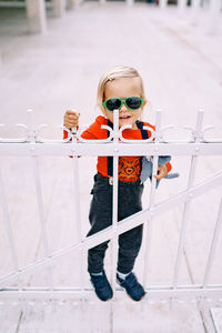 Portrait of boy standing against wall