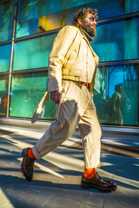 Midsection of man with umbrella on floor