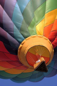 Hot air balloon in flight with flame from basket