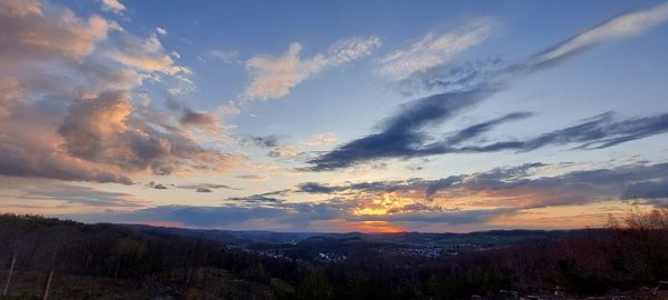 Scenic view of silhouette mountains against sky at sunset