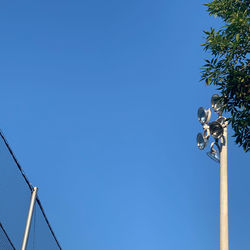 Low angle view of street light against clear blue sky