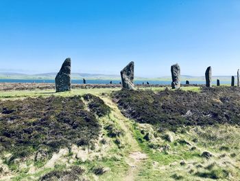 Big stones on land against clear sky