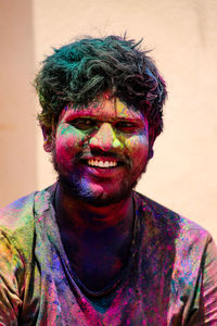 Close-up portrait of smiling man with face paint outdoors