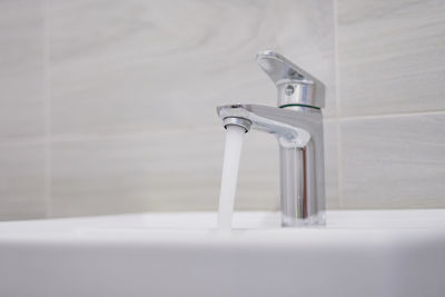 Close-up of faucet in bathroom