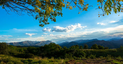 Scenic view of mountains against blue sky