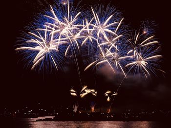 Low angle view of firework display at night