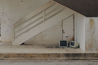 Abandoned television set and monitor by railing