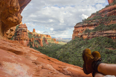 Low section of man relaxing in canyon