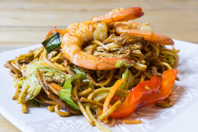 Close-up of shrimps with noodles served on table