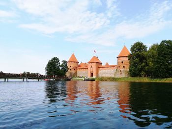 View of river by city against sky