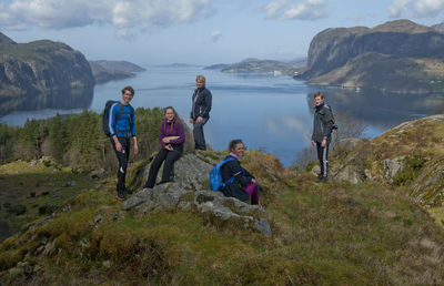 People enjoying on mountain against sky