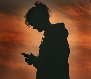 Low angle view of people at sunset