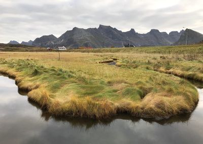 View of stream against cloudy sky